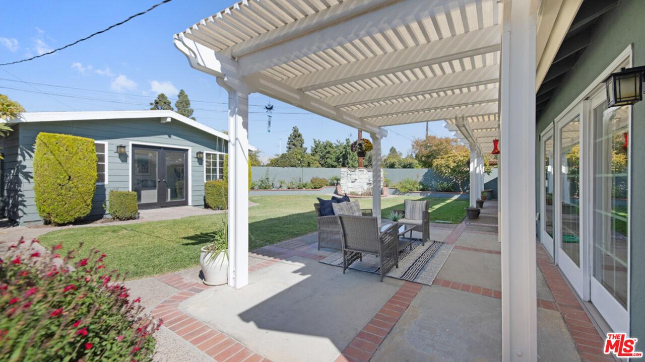 5601 Middlecoff Drive Huntington Beach, CA 92649 - Photo 35 of 49 a view of a patio with a table chairs and a backyard