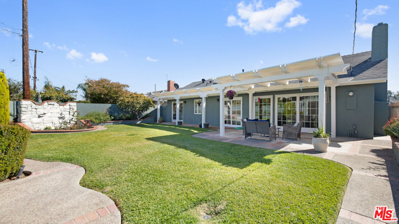 5601 Middlecoff Drive Huntington Beach, CA 92649 - Photo 36 of 49 a view of a house with backyard sitting area and garden