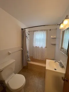 a bathroom with a toilet and shower