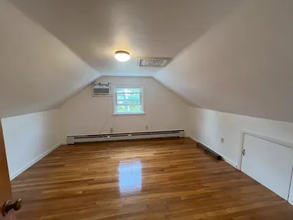a view of a room with wooden floor and white walls
