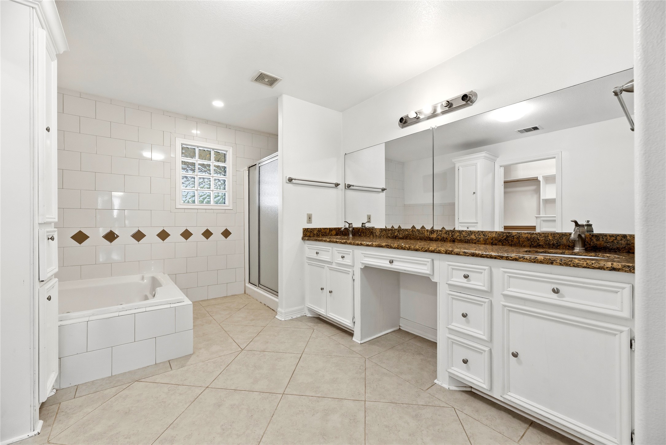 523 Moore Bar Road Rosenberg, TX 77471 - Photo 46 of 50 The primary bath features double sinks, a vanity area, a jetted tub and separate shower.