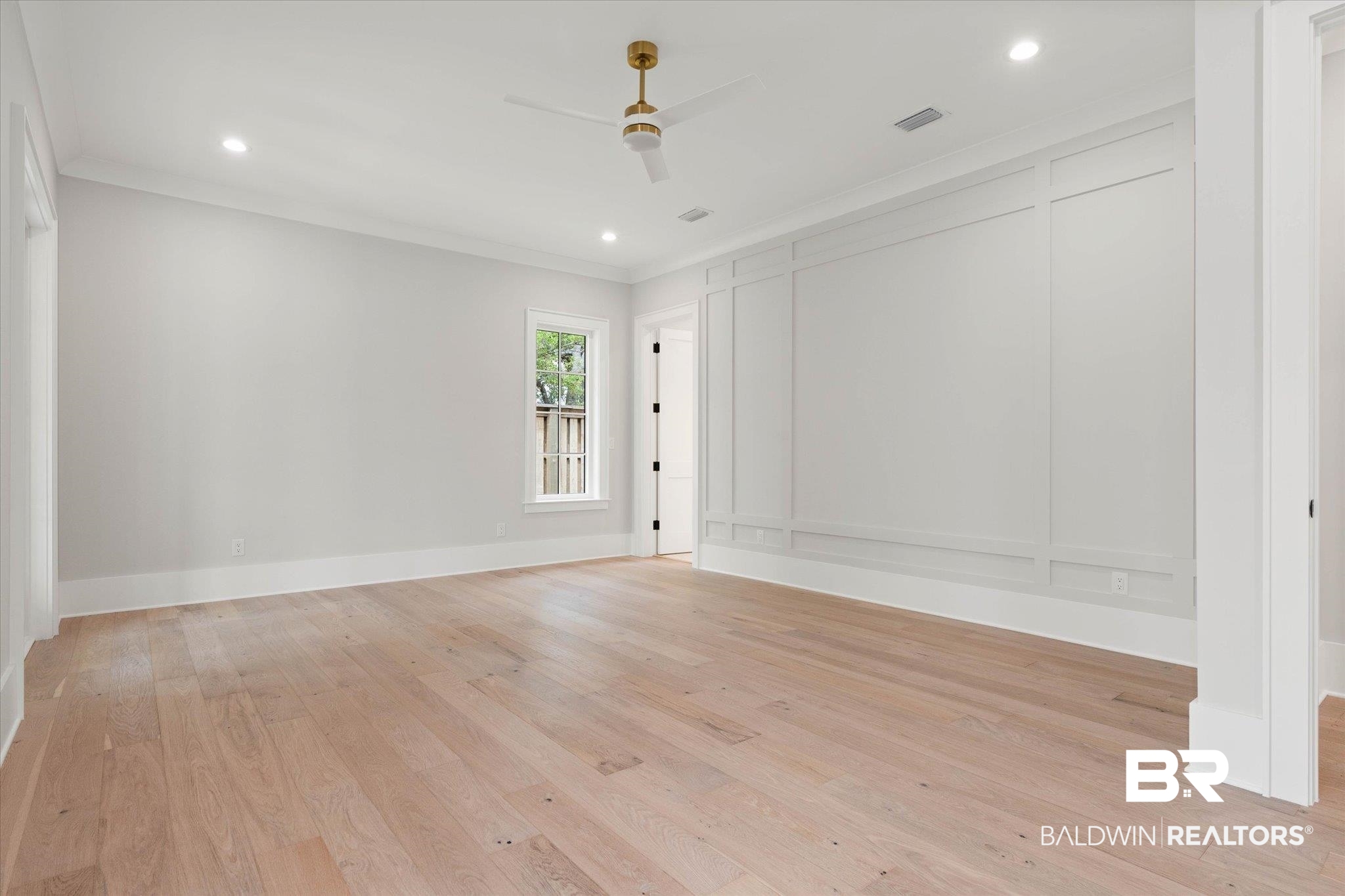 853 Inlet Circle Gulf Shores, AL 36542 - Photo 17 of 55 Empty room with crown molding, a decorative wall, ceiling fan, recessed lighting, and light wood finished floors