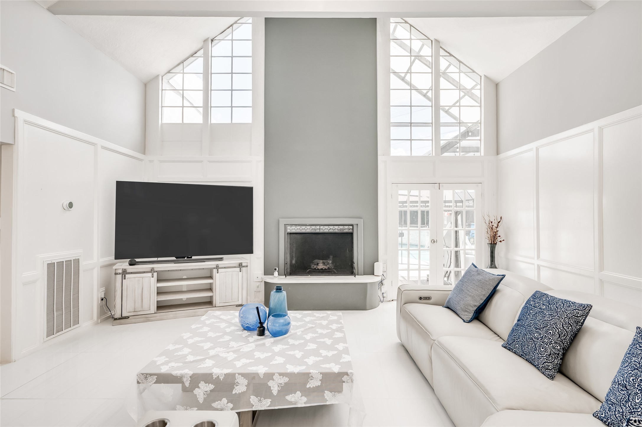 The centerpiece of this inviting space is a striking fireplace, serving as a captivating focal point that adds warmth and charm.