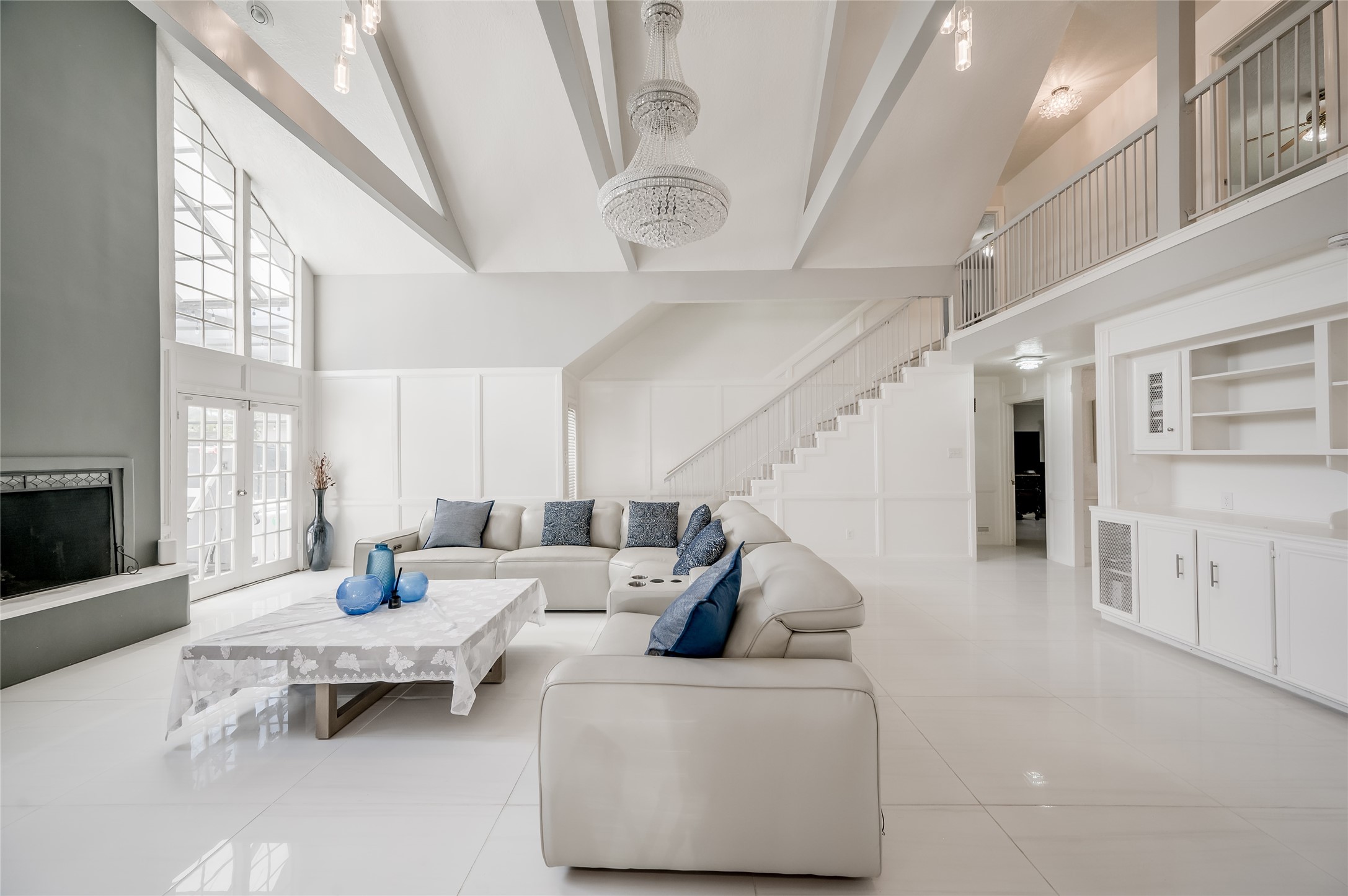 611 Montclair Boulevard Sugar Land, TX 77478 - Photo 13 of 50 This stunning living room is the epitome of modern living. The open layout and contemporary design make this living room an ideal space for both relaxing and hosting gatherings, blending style, comfort, and functionality seamlessly.