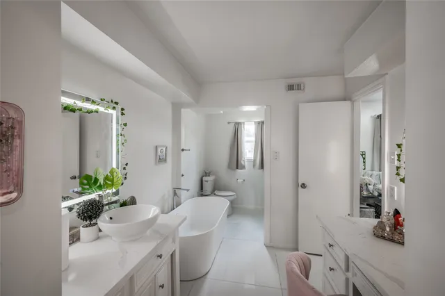 a bathroom with a sink toilet and mirror