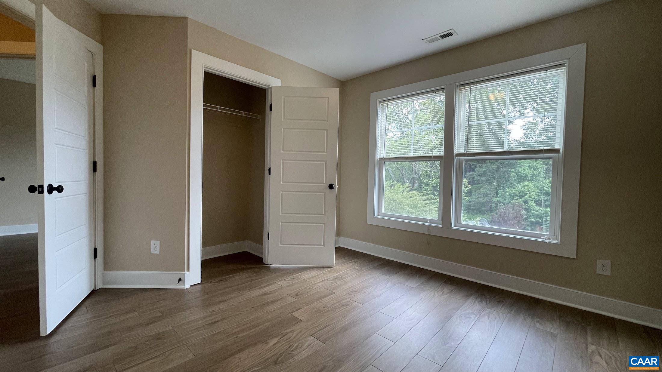 200 Harris Road Charlottesville, VA 22903 - Photo 25 of 28 an empty room with wooden floor and windows