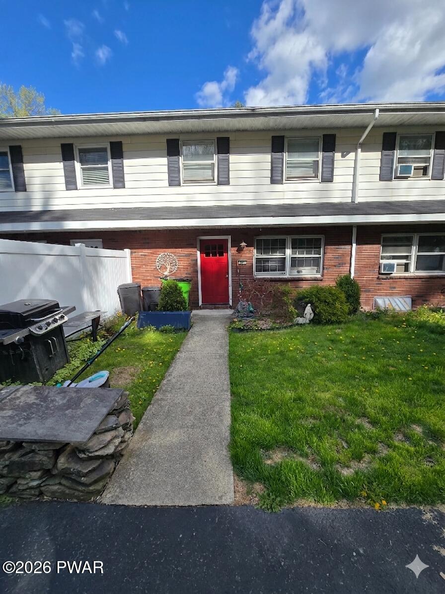 107 Keystone Hls Road, Unit 404 Factoryville, PA 18419 - Photo 1 of 23 a front view of a house with a yard and garage
