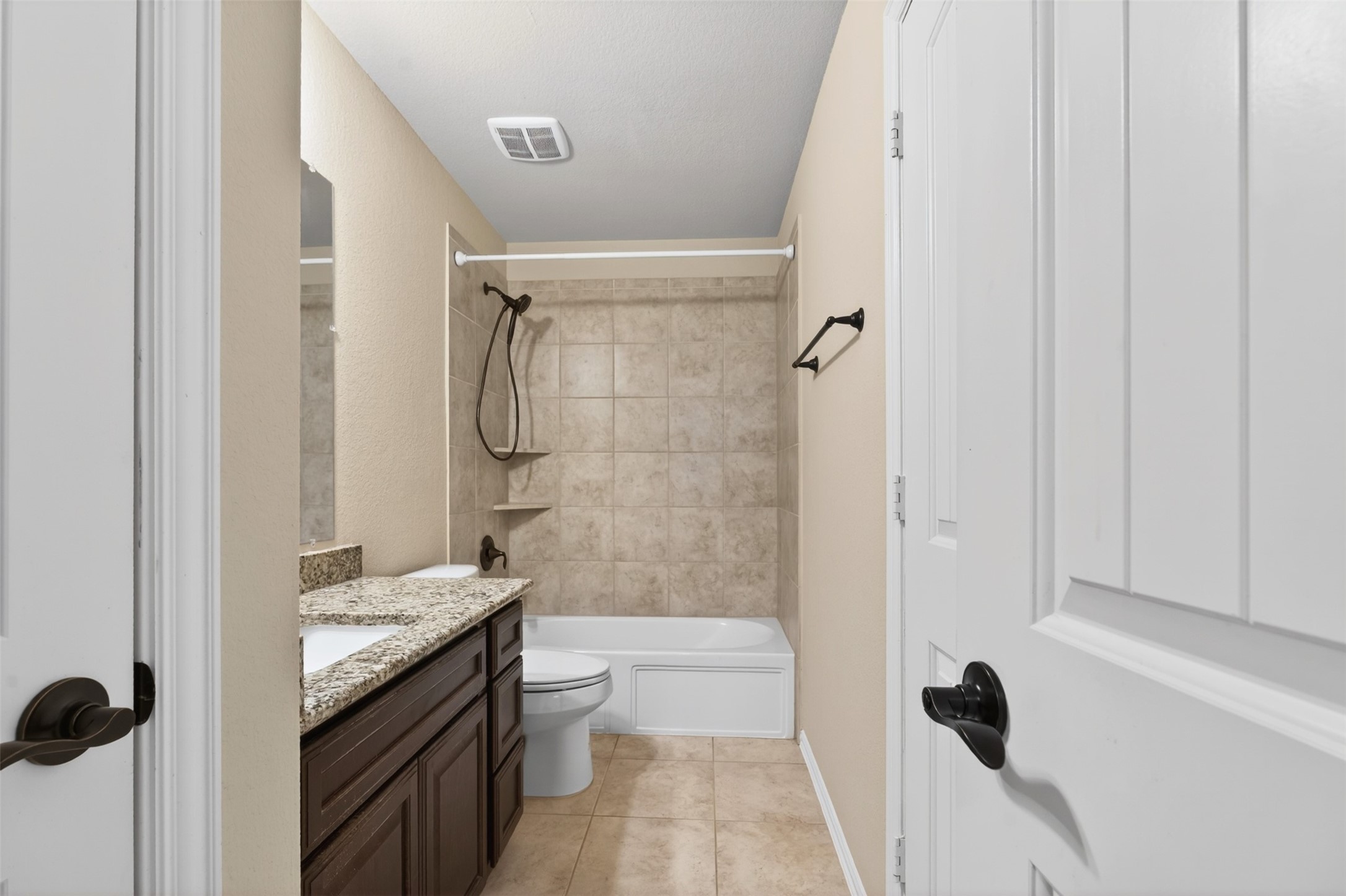 18202 Wedgewood Bluff Court Spring, TX 77379 - Photo 39 of 50 Secondary bathroom with tub/shower combination and neutral tile surround.