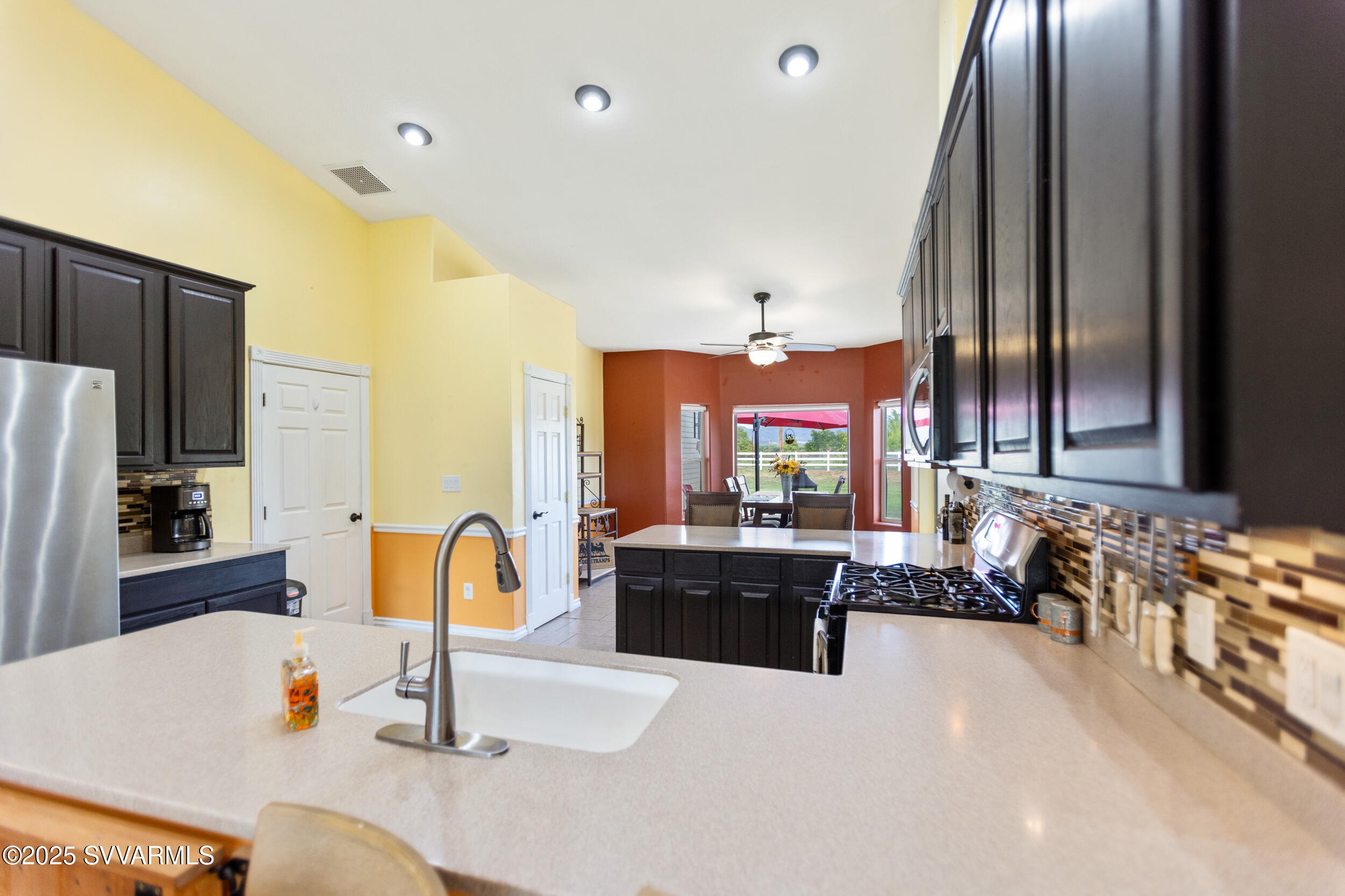455 East Flint Knap Way Camp Verde, AZ 86322 - Photo 12 of 49 a kitchen with stainless steel appliances granite countertop a sink and a refrigerator