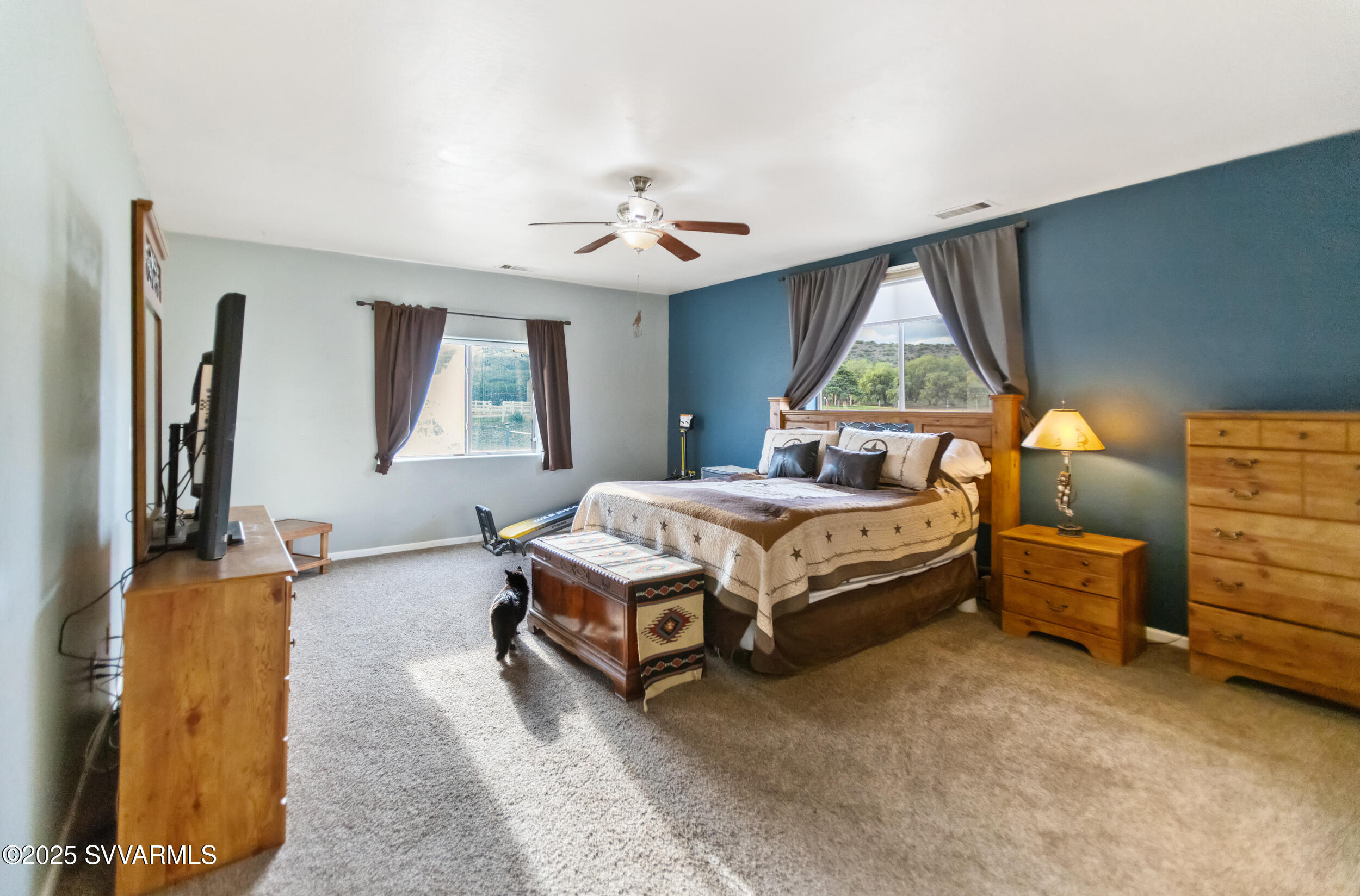 455 East Flint Knap Way Camp Verde, AZ 86322 - Photo 17 of 49 a spacious bedroom with a bed and a chandelier