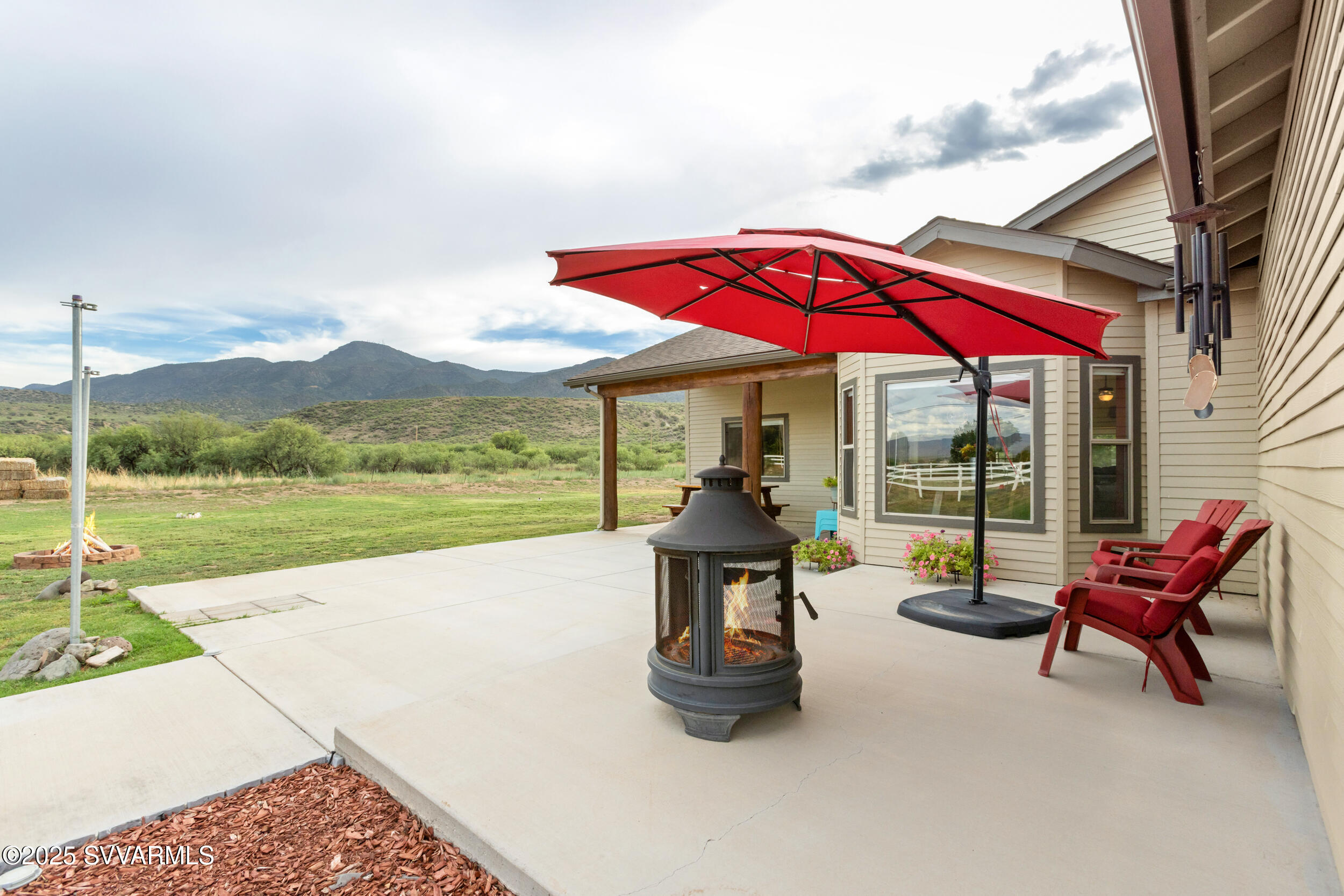 455 East Flint Knap Way Camp Verde, AZ 86322 - Photo 2 of 49 a view of pool with a table and chairs under an umbrella