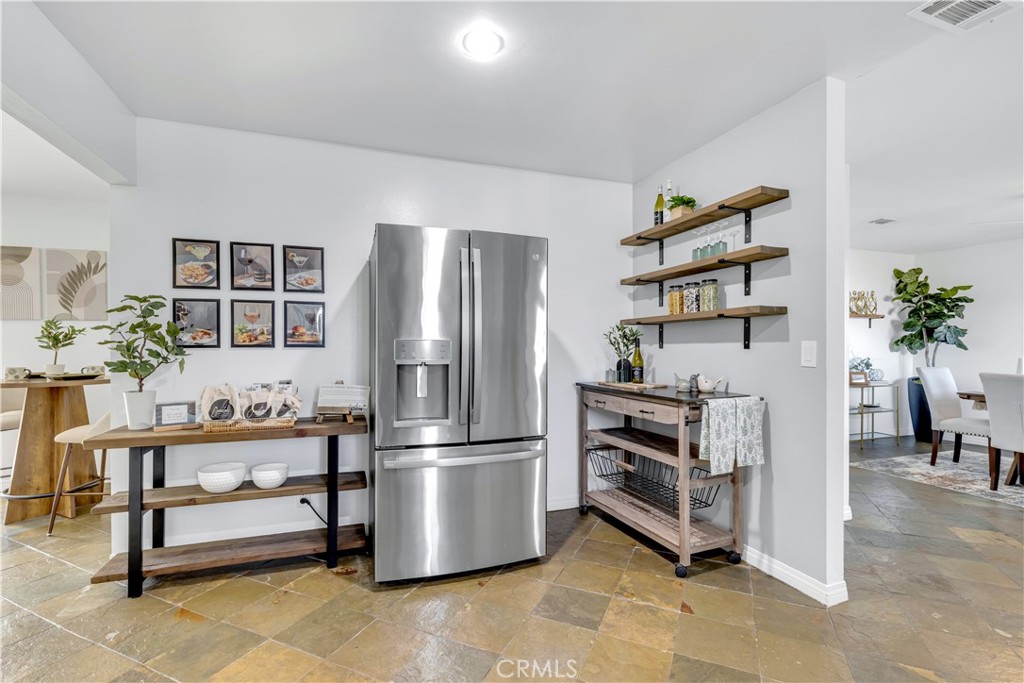 209 Madison Street Oceanside, CA 92057 - Photo 11 of 28 a kitchen with a refrigerator and potted plant