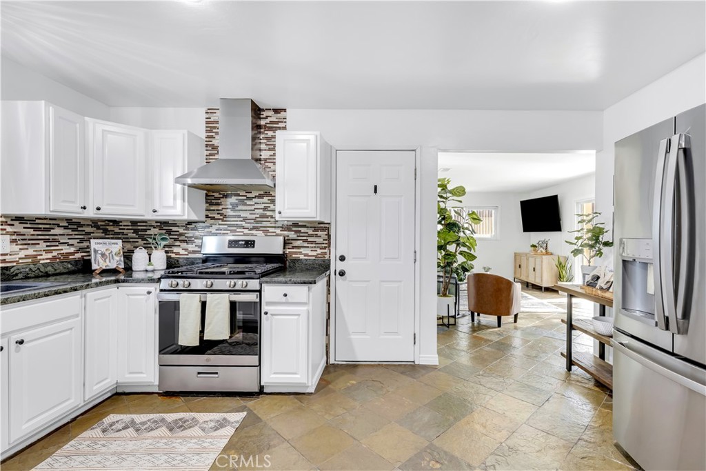 209 Madison Street Oceanside, CA 92057 - Photo 12 of 28 a kitchen with stainless steel appliances a stove a sink and a refrigerator