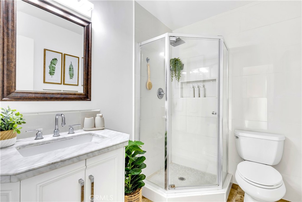 209 Madison Street Oceanside, CA 92057 - Photo 17 of 28 a bathroom with a granite countertop sink toilet and shower