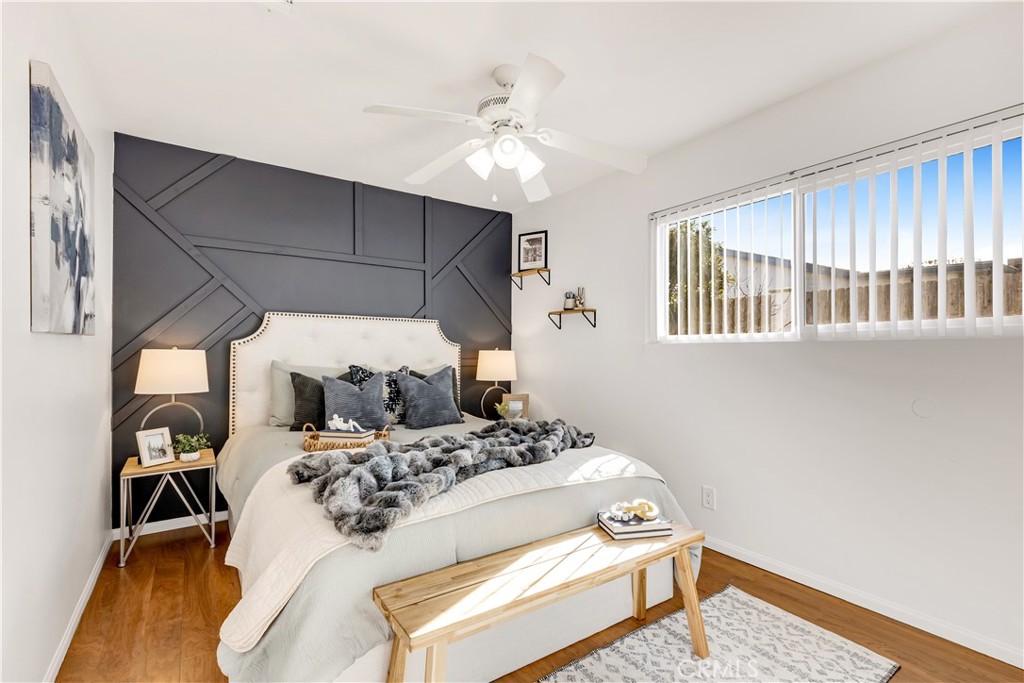 209 Madison Street Oceanside, CA 92057 - Photo 19 of 28 a bedroom with a bed and a chandelier