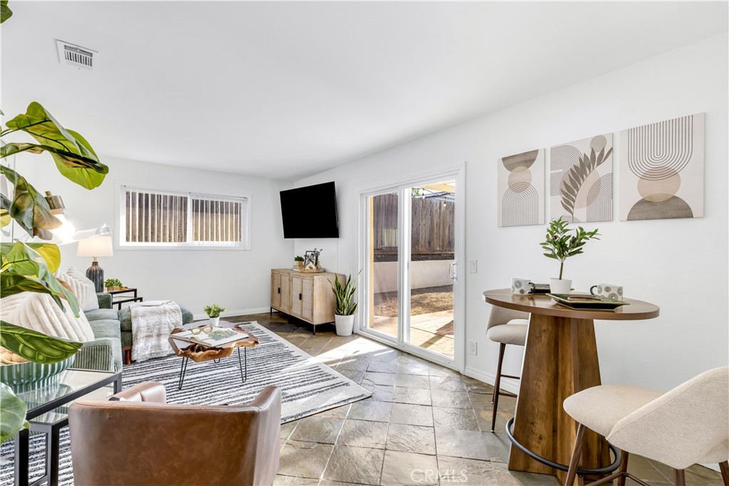 209 Madison Street Oceanside, CA 92057 - Photo 21 of 28 a living room with furniture a flat screen tv and a table