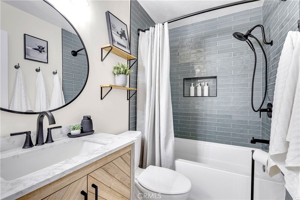 209 Madison Street Oceanside, CA 92057 - Photo 4 of 28 a bathroom with a sink a toilet and a mirror
