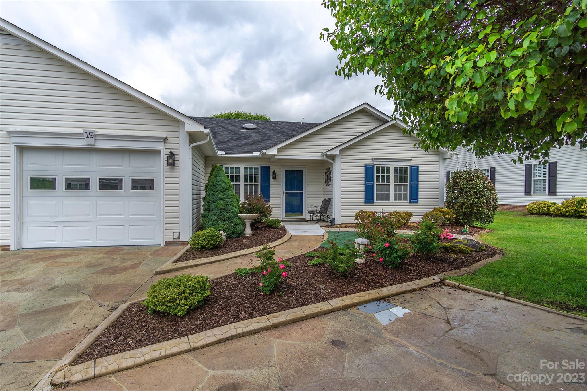 a front view of a house with garden