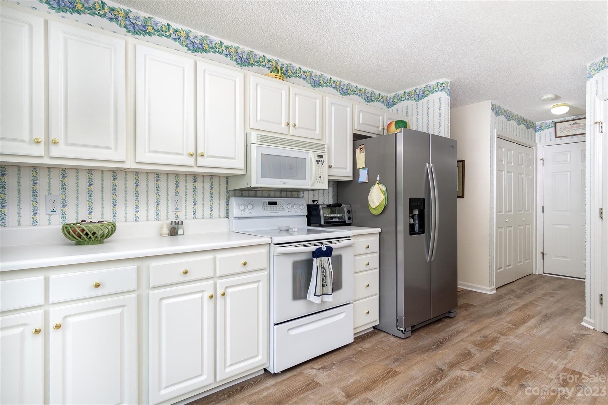 19 Briarbrook Road Fletcher, NC 28732 - Photo 31 of 46 a kitchen with white cabinets and white appliances