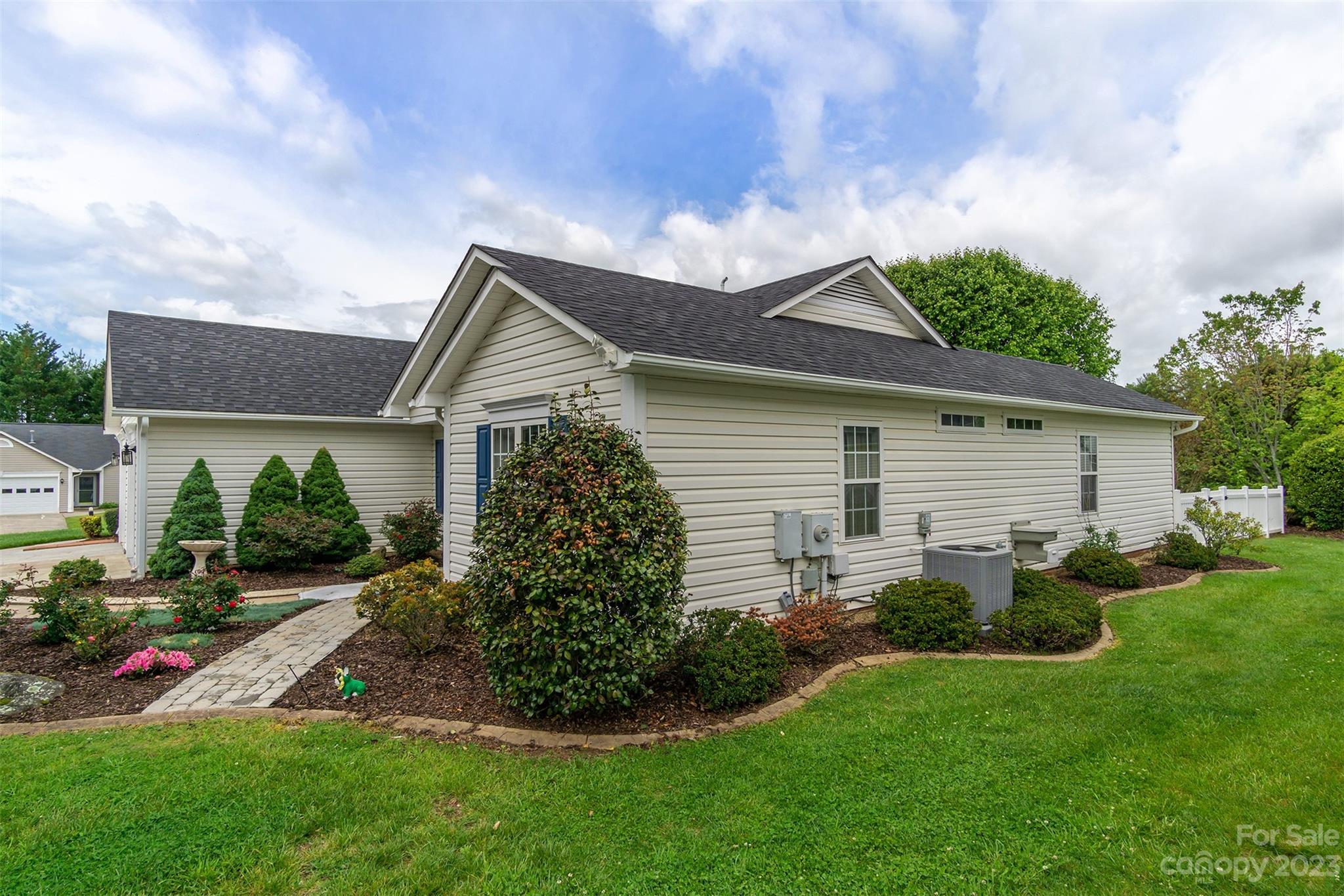 19 Briarbrook Road Fletcher, NC 28732 - Photo 42 of 46 a backyard of a house with potted plants and a large tree