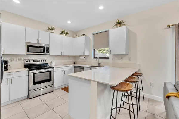 a kitchen with a sink cabinets and appliances