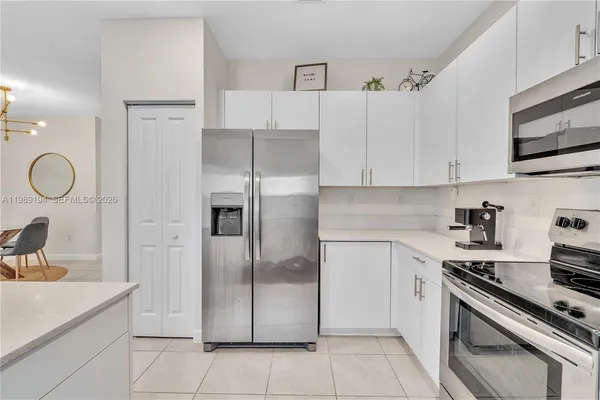 a kitchen with stainless steel appliances cabinets a sink and a counter top space