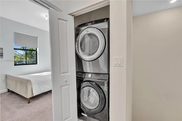 a view of a bedroom with washer and dryer