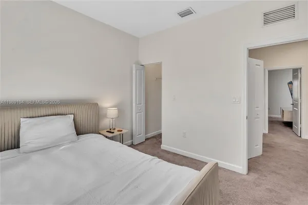 a bedroom with a bed and a lamp