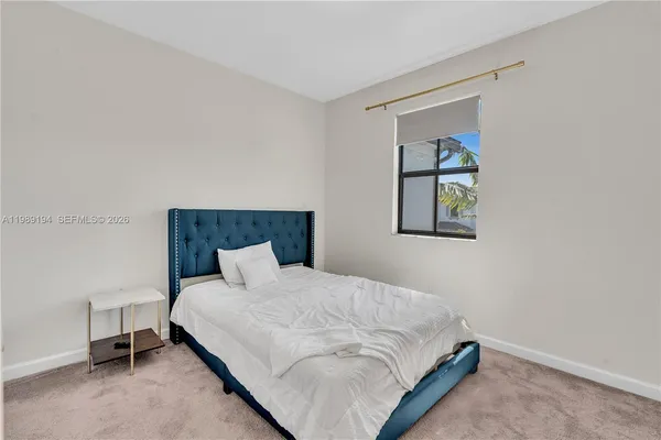 a bedroom with a bed and a desk