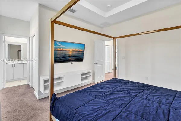 a bedroom with a bed and a flat screen tv