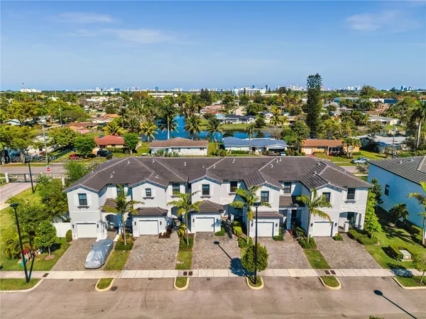 an aerial view of residential houses with outdoor space