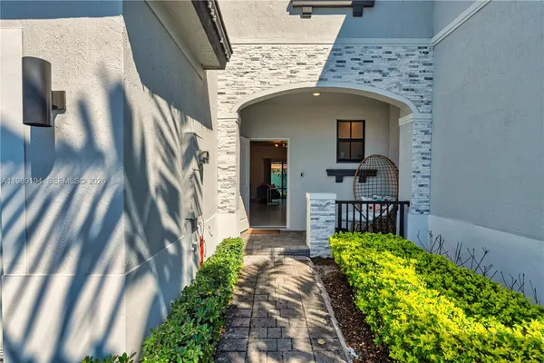 a view of a house with potted plants
