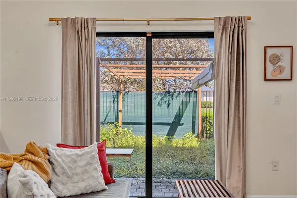 a view of a porch with furniture and garden