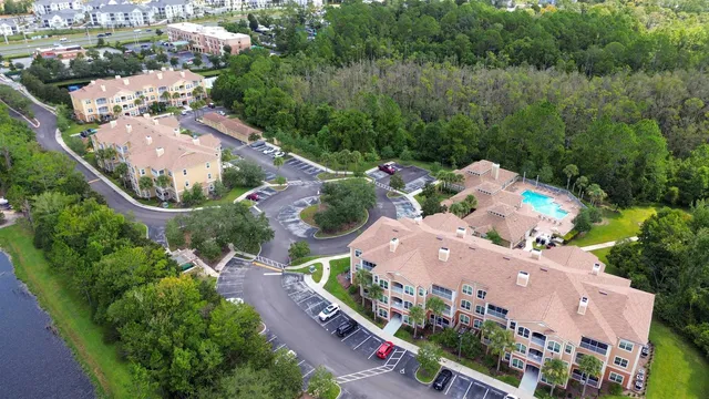 an aerial view of a house with a garden and lake view