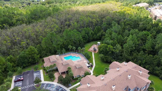 an aerial view of a house with a yard and outdoor seating