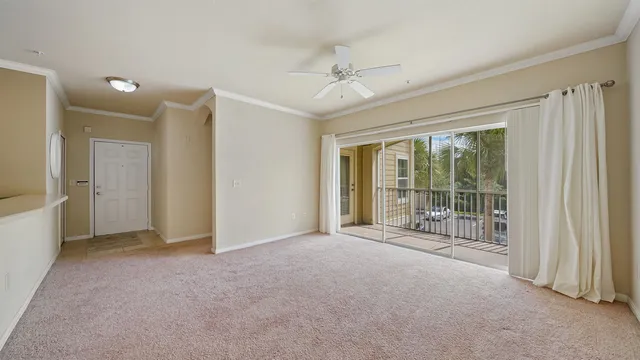 an empty room with fan and windows