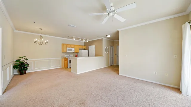 a open kitchen with granite countertop a stove top oven a sink a counter space and cabinets