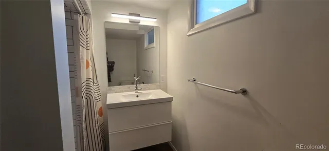 a bathroom with a sink and mirror