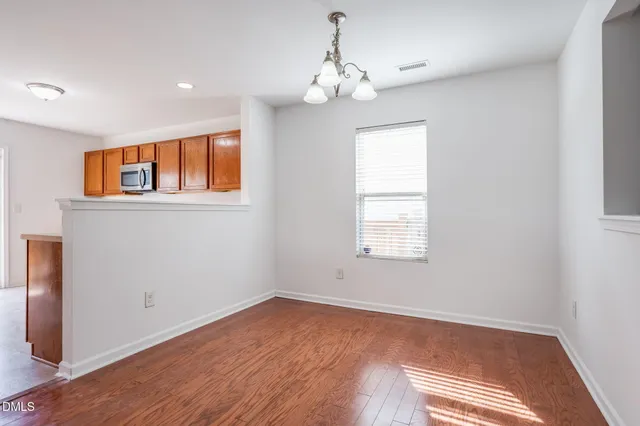 a kitchen with stainless steel appliances granite countertop a stove a sink and a refrigerator with cabinets