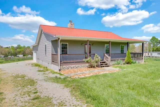 a view of a chair and table in backyard of the house