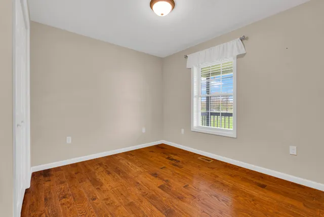 a bed sitting in a bedroom next to a window