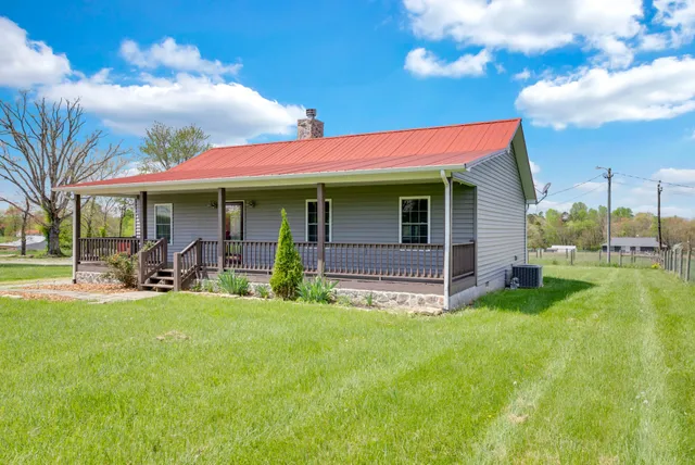 a view of a house with backyard porch and sitting area
