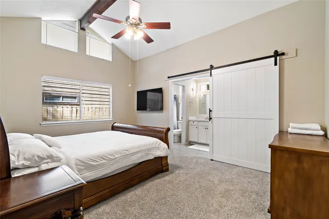 a bedroom with a bed dresser and a window