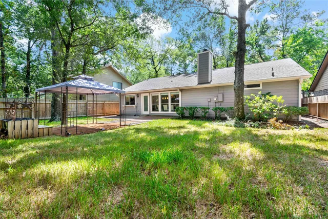 a view of a house with a yard and sitting area