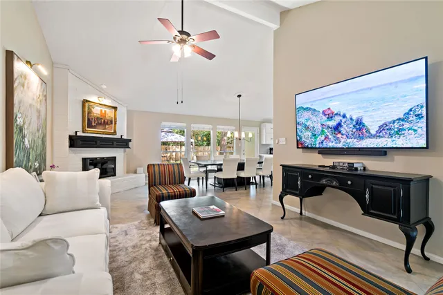 a living room with fireplace furniture and a flat screen tv
