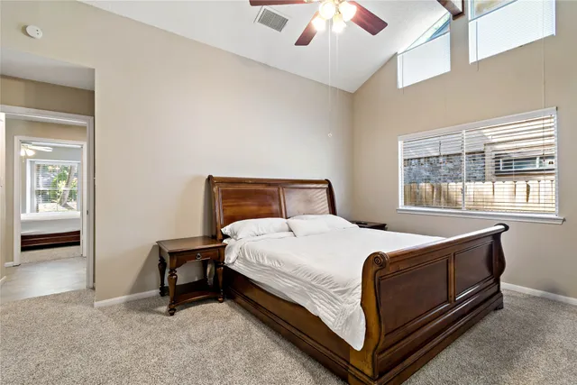 a bed sitting in a bedroom next to a window