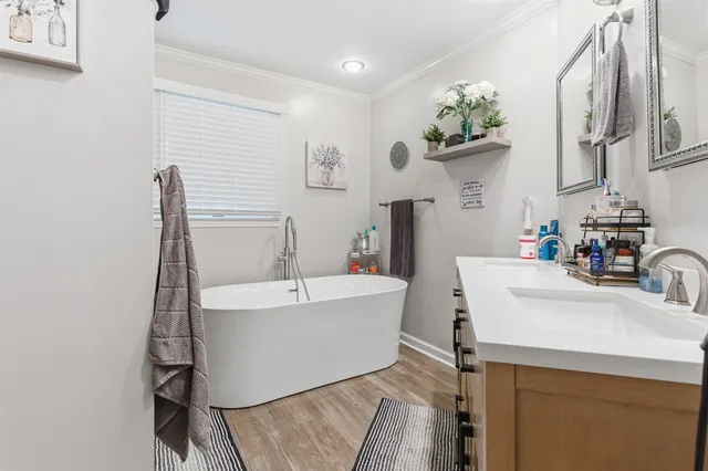 a bathroom with a sink a mirror and a bathtub