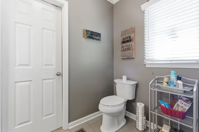 a white toilet sitting next to a bathroom sink