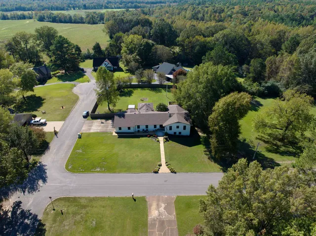 an aerial view of a house with a garden and swimming pool