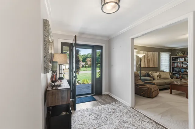 a living room with furniture and a floor to ceiling window